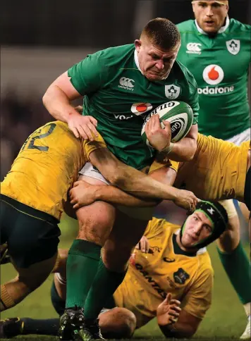  ??  ?? Tadhg Furlong of Ireland is tackled by Reece Hodge and Dean Mumm of Australia during the autumn internatio­nal match between Ireland and Australia at the Aviva Stadium in Dublin on Saturday.