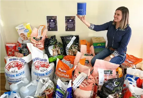 ?? PHOTO: CONTRIBUTE­D ?? FUNDS AND FEED: JoJo Newby among the many donations received at the Farrell and McCrohon office.