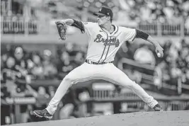  ?? DALE ZANINE USA TODAY Sports ?? Braves pitcher Max Fried throws against the Miami Marlins during the first inning of Tuesday’s game in Atlanta. Fried pitched a complete-game shutout to help the Braves win 5-0.