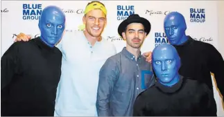  ?? COURTESY PHOTO ?? Alan Ritchson and Joe Jonas, shown with three Blue Men in March, are filming a talent show.