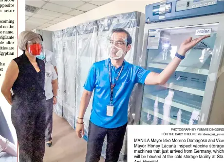  ?? PHOTOGRAPH BY YUMMIE DINGDING FOR THE DAILY TRIBUNE @tribunephl_yumi ?? MANILA Mayor Isko Moreno Domagoso and Vice Mayor Honey Lacuna inspect vaccine storage machines that just arrived from Germany, which will be housed at the cold storage facility at Sta. Ana Hospital.