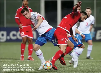  ??  ?? Malta's Zach Muscat (R) battles it out with Johannes Bjartalio of the Faroe Islands.