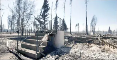  ?? ?? The Canadian Press
A set of steps is all that remains of a house in Slave Lake, Alta. in a file photo from 2011.