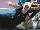  ?? FERNANDO LLANO/AP ?? Poland’s Iga Swiatek poses for photos after winning the WTA Finals last year in Mexico. The WTA announced on Thursday that the season-ending event for the top eight women’s singles players and doubles teams will take place in Saudi Arabia from 2024 to 2026.