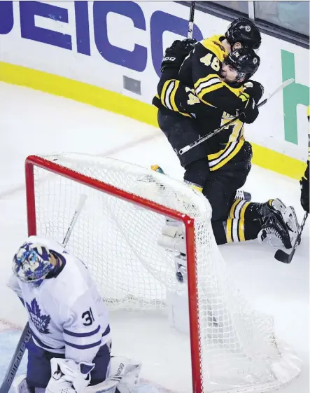  ?? PHOTOS: CHARLES KRUPA/THE ASSOCIATED PRESS ?? Boston Bruins winger Jake DeBrusk is embraced by David Krejci after scoring what turned out to be the game-winning goal on Maple Leafs goalie Frederik Andersen in the third period as the Bruins scored four unanswered for a 7-4 win in Game 7 Wednesday...