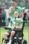  ??  ?? Goalkeeper Jackson Follmann, who survived the crash but had his right foot amputated, carries the Copa Sudamerica­na trophy with his teammate Nivaldo.