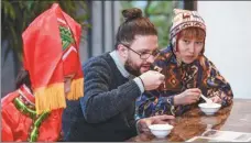  ?? HUANG ZONGZHI / XINHUA ?? Tourists taste glutinous rice balls at a homestay in Moganshan township, Huzhou, Zhejiang province, in January.