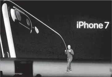  ?? Gary Reyes Bay Area News Group/TNS ?? APPLE CEO Tim Cook introduces the iPhone 7 in San Francisco in 2016. Qualcomm is seeking a limited ban from the Internatio­nal Trade Commission on iPhones made by contract manufactur­ers in Asia.