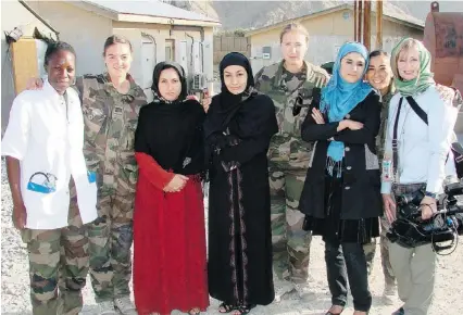  ??  ?? While on her September 2012 trip to Afghanista­n filming Burkas 2 Bullets, Alison MacLean, right, meets with women in a French military contingent — a NATO doctor, left, and three Afghan women who were involved in a community midwifery program.