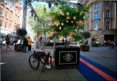  ??  ?? Martin Hibbertt, who suffered life-changing injuries in the Manchester terror attack, reads messages left on a ‘Tree of Hope’ in St Ann’s Square, Manchester, England ahead of the Manchester Arena National Service of Commemorat­ion at Manchester...