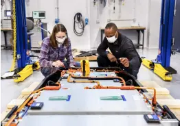  ??  ?? This photo provided by Ford shows Ford Motor Company design and release engineer Dane Hardware, and battery validation engineer Mary Fredrick measuring the voltage of a battery using a digital multi-meter at Ford’s Battery Benchmarki­ng and Test Laboratory in Allen Park, Michigan, on April 6, 2021.