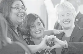  ?? Marie D. De Jesus / Houston Chronicle ?? Mayor Annise Parker makes a heart sign with other HERO supporters Griselda Velazquez, left, and Michelle Garcia during the election night watch party for the Houston Equal Rights Ordinance.