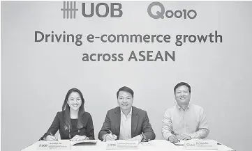  ??  ?? (From left) UOB Personal Financial Services Singapore head Jacquelyn Tan, Loh, Ku sign a Memorandum of Understand­ing to drive e-commerce growth across Asean.