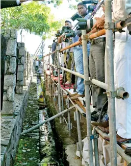  ??  ?? Journalist­s were given a platform adjoining a drain to cover the candidates who came to hand over nomination­s at the Elections Secretaria­t. Pic by Indika Handuwala