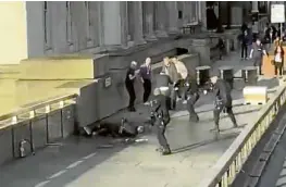  ?? —AP ?? LONDON BRIDGE FALLEN In this grab taken from a video from @HLOBLOG, a man is surrounded by police after a stabbing on London Bridge on Friday.