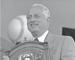  ?? AP FILE PHOTO ?? Tommy Lasorda poses with his Hall of Fame plaque after his induction in Cooperstow­n, N.Y., in 1997. Lasorda has died at age 93, the Dodgers said Friday.