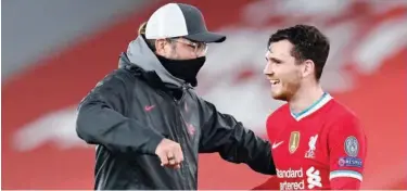 ?? Associated Press ?? ↑
Liverpool’s manager Jurgen Klopp (left) celebrates with Andrew Robertson after their victory over Ajax in a Champions League match.
