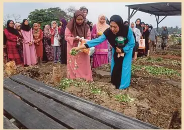  ??  ?? HANAIATI menyiram air ke pusara Nur Alya Damia yang dikebumika­n di Tanah Perkuburan Islam Selat Kelang.