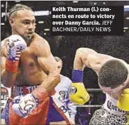  ??  ?? Keith Thurman (l.) connects en route to victory over Danny Garcia.