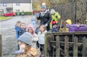  ??  ?? Slippy leaves Youngsters prepare to clean path