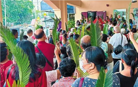  ?? ?? Blessing of palms: Father Paul das (centre back) from our Lady of Fatimah church in Brickfield­s beginning the Palm Sunday procession.