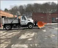  ?? NICHOLAS BUONANNO — NBUONANNO@TROYRECORD.COM ?? A vehicle in Troy on Tuesday prepares for the storm.