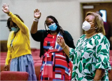  ?? STEVE SCHAEFER FOR THE ATLANTA JOURNAL-CONSTITUTI­ON ?? Masked and socially distanced, members of the congregati­on of the Greater Piney Grove Baptist Church in DeKalb County come together to participat­e in Sunday’s service Aug. 29.