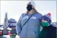  ?? Elise Amendola / Associated Press ?? Kelly Roccabello and her son, Giovanni, 6, speak to a reporter Monday outside the pro shop at Gillette Stadium in Foxborough, Mass.