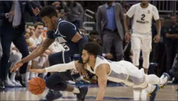  ?? DARREN HAUCK — THE ASSOCIATED PRESS ?? Villanova’s Saddiq Bey, left, battles Marquette guard Markus Howard for the ball in the second half of Marquette’s 66-65 victory Saturday. Bey has gone from under-the-radar prospect to one of the Wildcats’ top freshmen this season.