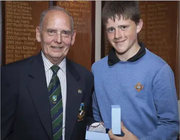  ??  ?? Tommy Keogh, who won the Baltinglas­s Golf Club juvenile prize at the captain’s prize, collects his award from Club Captain Louie Fagan.