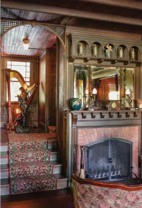  ??  ?? LEFT Guests often gather by the fireplace. In the nook leading upstairs sit an antique harp and a spelter maiden, long detached from the newel post in her former home.