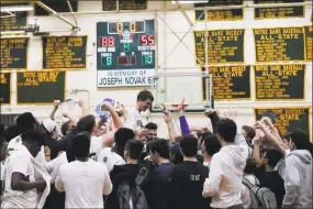  ?? Contribute­d photo ?? Notre Dame-West Haven team manager Matt Callahan was carried off the court after hitting a 3-pointer on Senior Night Friday against Career.