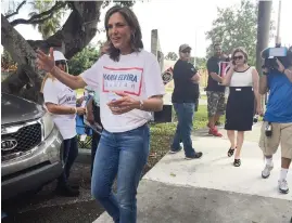  ??  ?? Former Spanish-language TV host Maria Elvira Salazar makes the rounds at Miami-Dade polling places in 2018 in her quest to replace Ileana Ros-Lehtinen for Congress in District 27.