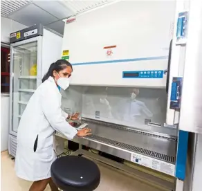  ??  ?? MMC Gamuda SARS-COV-2 testing laboratory manager Nava Yugavathy demonstrat­ing the use of the Biosafety Class II Cabinet at the lab.