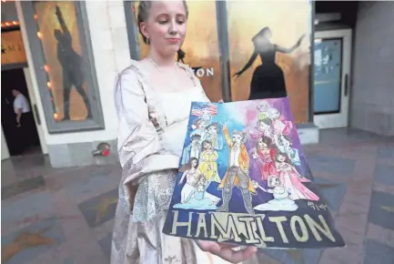  ??  ?? Ava Noe, 12, dresses as Hamilton character Angelica Schuyler on Tuesday, holding a playbill she created for opening night of the production, the start of its three-week run inmemphis. JOE RONDONE/THE COMMERCIAL APPEAL