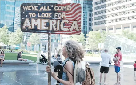  ?? — GETTY IMAGES ?? Bernie Sanders supporters gather in a public plaza Sunday before the start of the Democratic National Convention in Philadelph­ia, Pa. The convention officially begins on Monday and is expected to attract thousands of protesters, members of the media...