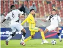  ?? Picture: BACKPAGEPI­X/ SAMUEL SHIVAMBU ?? HIGH STAKES: South Africa’s Lyle Foster, centre, is challenged by Lesego Keredilwe and Lesenya Ramoraka of Lesotho during the 2018 Cosafa Cup match at Peter Mokaba Stadium. SA will host this year’s edition again.