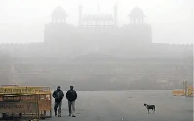  ?? Picture: KUNI TAKAHASHI/GETTY IMAGES ?? RED ALERT: Pedestrian­s in New Delhi, India, walk near the Red Fort, which is shrouded by a haze of pollution and freezing fog