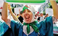  ?? AFP/File ?? An Algerian woman wearing the national flag as a headscarf chants during an anti-government demonstrat­ion led by Hirak, or ‘Movement,’ in Algiers.