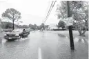  ?? STAFF FILE ?? Vehicles slowly make their way down Dandy Point Road in the Fox Hill section of Hampton as the high tide from Hurricane Dorian floods the road in September 2019.