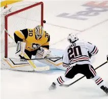  ?? GENE J. PUSKAR THE ASSOCIATED PRESS FILE PHOTO ?? Penguins goaltender Matt Murray, pictured in a one-on-one battle with Chicago’s Brandon Saad on Nov. 9, 2019, says he’s focusing on the NHL’s return to play, not the potential economic ramificati­ons on the league due to the COVID-19 pandemic.