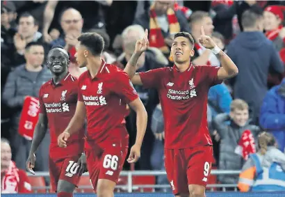  ?? — Reuters ?? Liverpool’s Roberto Firmino celebrates after scoring the winner against PSG during the Champions League.