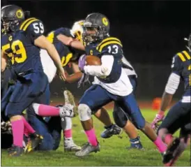  ?? GENE WALSH — DIGITAL FIRST MEDIA ?? Cheltenham’s Amir Watson burst through the line during game against Wissahicko­n Friday night.