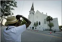  ?? CHUCK BURTON — THE ASSOCIATED PRESS ?? A photograph­er at Mother Emanuel AME Church in Charleston, S.C., on June 16, 2016. The church is among those that have been assisted by a fund to help historic Black churches, and a new, $20 million donation will help additional ones.