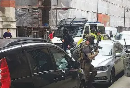  ?? AP PHOTO ?? Police prepre to enter an apartment complex in Manchester, England yesterday. More arrests have been made in connection with an explosion at a concert in the city Monday.