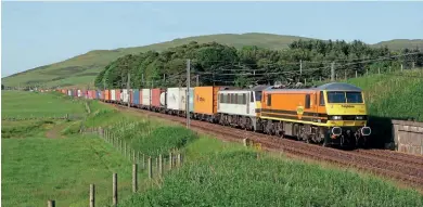  ?? ?? Pairs of Class 90s became well establishe­d on the West Coast main line, although a rise in electricit­y costs forced many trains to revert to diesel power for a time in the autumn. Nos. 90015 and 90013 pass Wandel, north of Crawford, with the 4M11 18.14 Coatbridge-Felixstowe train, on June 30.