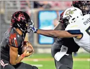  ?? / AP-Timothy D. Easley ?? Georgia Tech defensive lineman Antwan Owens grabs Louisville quarterbac­k Jordan Travis by the face mask during the second half of Friday’s game in Louisville, Ky.