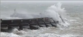  ??  ?? Gale force: huge waves crashing over the marina wall in Brighton today