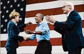  ?? MORRY GASH/AP ?? Former President Barack Obama greets candidates Sen. Tammy Baldwin and Tony Evers, who is running for governor, on Friday in Milwaukee. In his speech, Obama criticized President Donald Trump and other Republican­s for “making stuff up.”