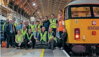  ?? GBRF / Tim Moran ?? Some of the volunteer staff from GB Railfreigh­t stand alongside 69002 Bob
Tiller CM&EE following its arrival at London Paddington on October 5, 2021, at the end of the GBRF 2021 railtour.